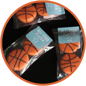 Oreo cookies covered in chocolate and hand decorated as basketballs athletics and sports