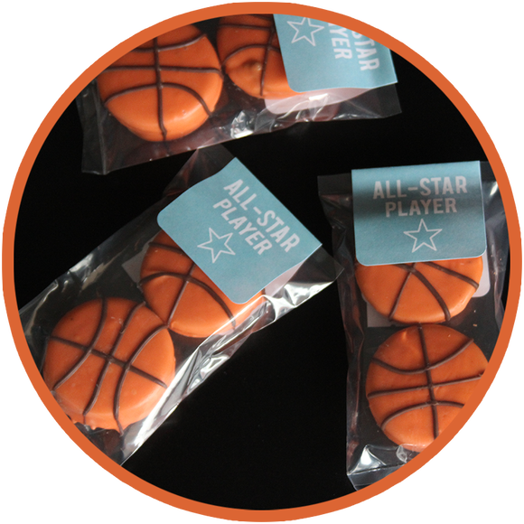 Oreo cookies covered in chocolate and hand decorated as basketballs athletics and sports