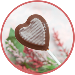 Chocolate heart lollipops with a pink or red rose. Hand molded chocolates from Kalona, Iowa.