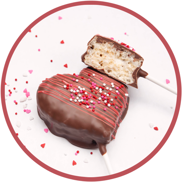 Heart shaped rice krispy treat on a stick and covered in chocolate.