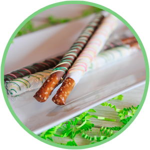 Brightly colored chocolate dipped pretzel rod sticks for Easter baskets.