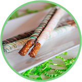 Brightly colored chocolate dipped pretzel rod sticks for Easter baskets.
