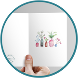 Hand painted card with vases of flowers and greenery.