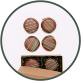 Handmade mint chocolate truffles in a small chocolate box.